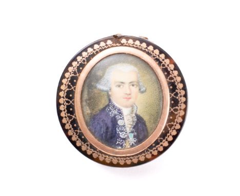 A late 18th century tortoiseshell and gold piquet work snuff box: of circular outline, the hinged lid inset with miniature po