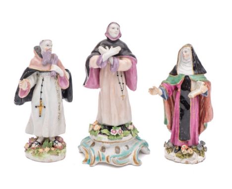 A matched pair of Bow standing figures of an Abbot &amp; Abbess together with a similar figure of an Abbess: the Abbess holdi