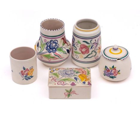 A group of five pieces of Poole Pottery: decorated with a range of floral designs, comprising a cigarette box and cover, impr