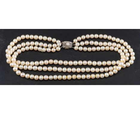 A three row, cultured pearl necklace of uniform size,: the pearls of creamy body colour with pinkish overtones, diameter ca. 