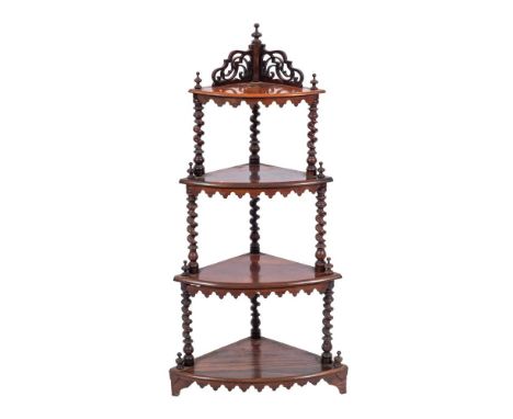 A Victorian rosewood four tier corner whatnot, circa 1880,: the upper shelf with fret carved openwork gallery back and turned