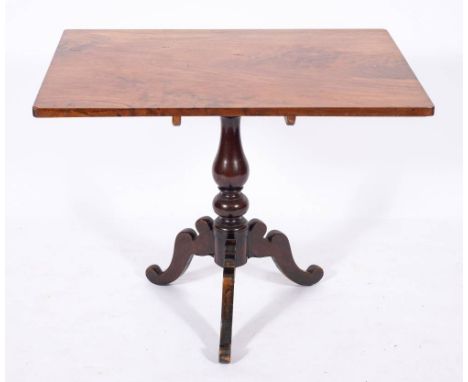 A George III mahogany tripod table, circa 1765,: the single piece hinged rectangular top above a baluster turned stem, to hip