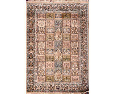 A Kashmir rug:, with a shaded pink, pastel blue and green compartmented garden design, enclosed by a main shaded pink medalli