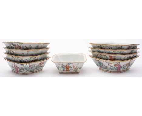 A Chinese famille rose nine-piece hors d'oeuvre's set: comprising eight sections around a central shaped square bowl enamelle