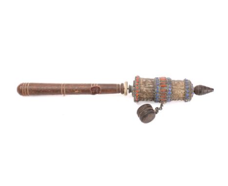 A Tibetan prayer wheel:  with wooden and enamel bound spinning top with chained weight,  mounted on a ring turned wood handle
