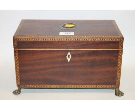 A VINTAGE INLAID MAHOGANY TEA CADDY ON BRASS CLAW FEET 