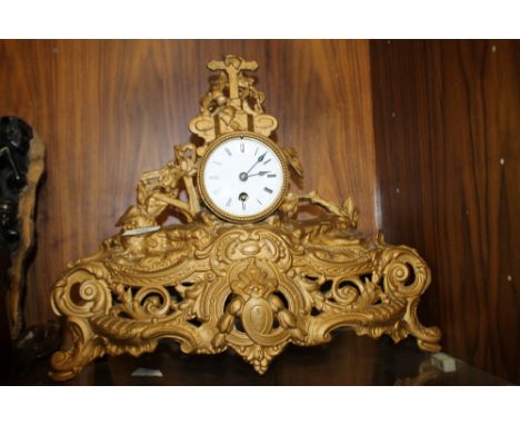 A GILT METAL ORNATE MANTLE CLOCK