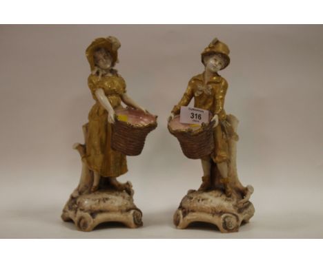 A PAIR W &amp; R AUSTRIAN SPILL VASE CERAMIC FIGURES OF A GIRL AND BOY CARRYING BASKETS A/F