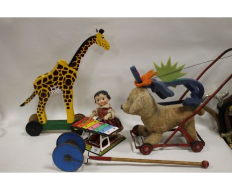 A VINTAGE WIND UP TINPLATE CHILD PLAYING A XYLOPHONE TOY TOGETHER WITH A SELECTION OF VINTAGE PUSH ALONG TOYS