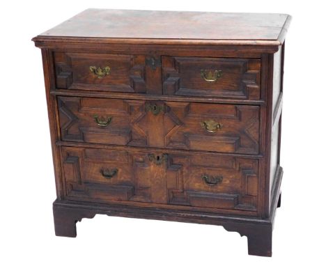 An 18thC oak chest of drawers, the top with a moulded edge above two short and two long panelled drawers, on later bracket fe