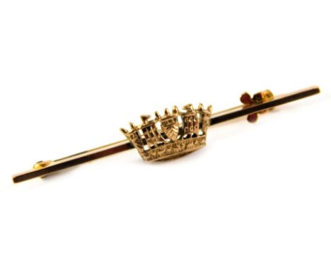 A bar brooch, set with central crown, on fine link pin, yellow metal stamped 9ct, 4cm wide, 2.2g all in, in a Gieves Limited 