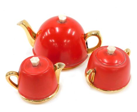 A Beverley three piece Art Deco tea service, with red coloured metal covers, the teapot, 22cm wide. 