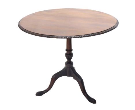 A 19thC walnut occasional table, the circular top with a carved border, on a turned column, tripod base with pad feet, 85cm d