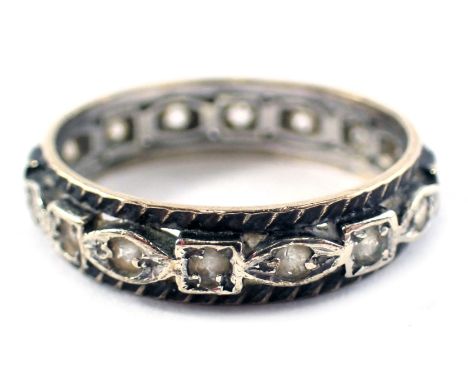 An eternity ring, set with white paste stones, in white and yellow metal believed to be 9ct gold and silver but unmarked, rin