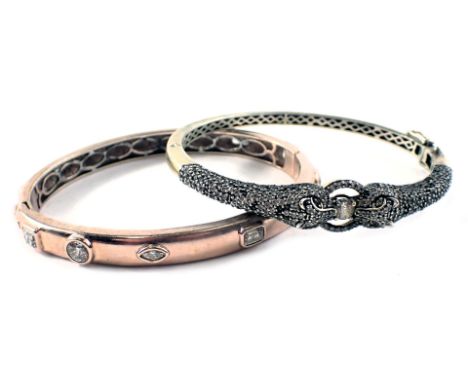 Two hinged bangles, comprising a white metal snake ring bangle, and a rose gold coloured silver bangle set with paste stones.