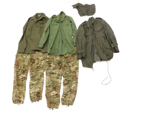 Army clothing, comprising green military jacket, two green military shirts, and a pair of camouflage trousers. 