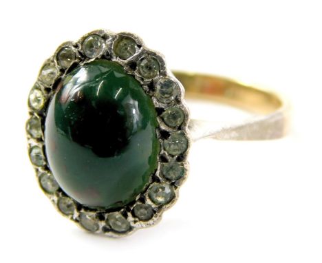 A dress ring, set with black stone and imitation diamonds, in a raised basket on a yellow and white metal band, stamped 9ct, 