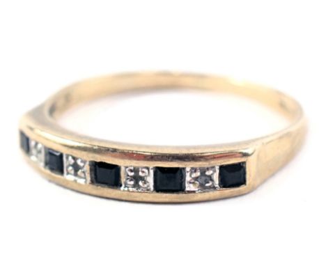 A 9ct gold half hoop dress ring, the panel set with five sapphires and four tiny diamonds, in platinum on a yellow metal band