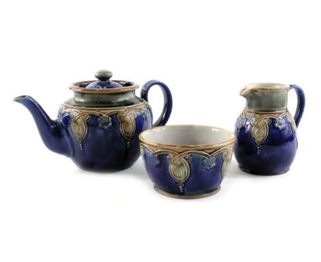 Three Royal Doulton Lambeth wares, comprising a teapot, milk jug, and sugar bowl, stamped 4965. 