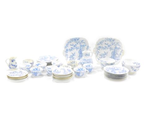 A Victorian porcelain part tea and dinner service, decorated in Oriental style with a mythical dragon like beast, birds, flow
