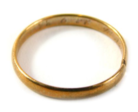 A wedding band, of plain design with internal rubbed inscription cut, yellow metal unmarked, 1.9g all in. 