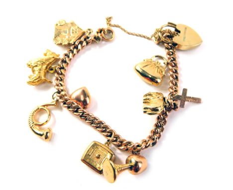 A 9ct gold curb link bracelet, set with nine charms, to include spotty dog, house, goblet and others, with safety chain and p