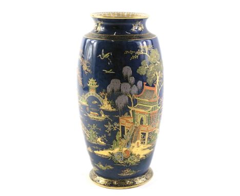 A Carltonware lustre vase, on a blue mottled ground with painted oriental figures and buildings, with a gilded border, 27cm h