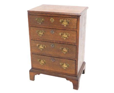 A late 18th/early 19thC oak small chest of drawers, the top with a moulded edge, with four drawers each with brass drop handl