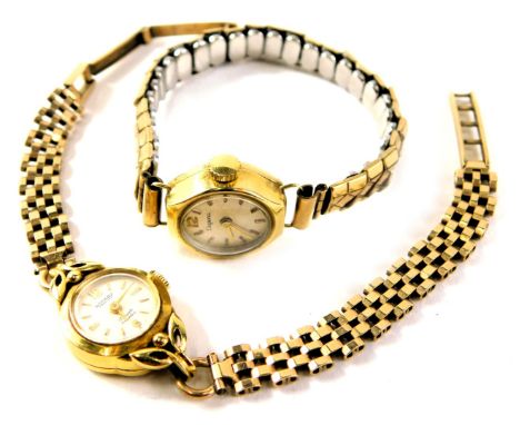 A Rotary lady's wristwatch, with a silvered dial, on three bar bracelet on a 9ct gold strap, in a yellow metal case stamped 1