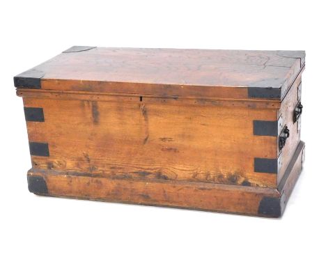 A late 19th/early 20thC elm and ebonised metal chest, the hinged top enclosing a vacant interior, with two pairs of brass car