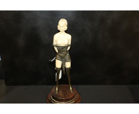 Art Deco style figure depicting a scantily clad lady holding a riding crop, 32cm high