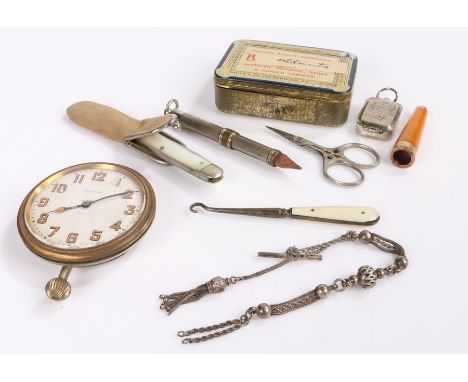 Works of art, to include an amber and gold cigarette holder, a knife, button hook, pencil, watch chain, stand and clock, (8)