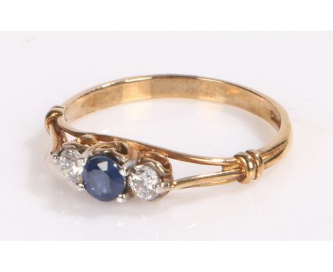 9 carat gold sapphire and cubic zirconia ring, the pierced shoulders leading to heart shape head with a sapphire central to t