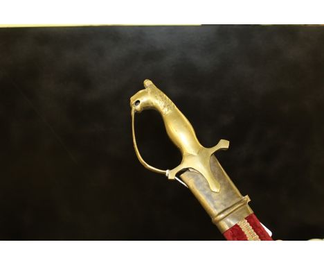 Indian sword, with lion pommel and red velvet decorated scabbard, 84cm long