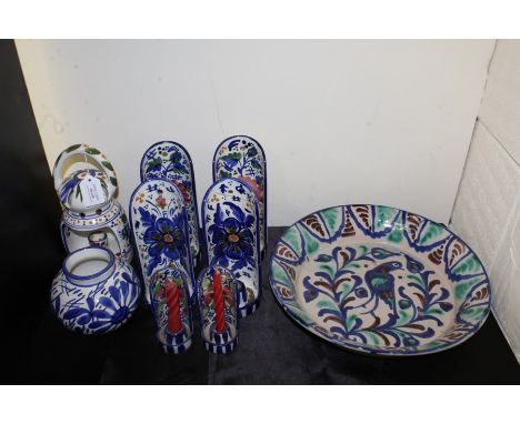 Pottery, to include a dish decorated with a central bird, a set of candle holders a lantern and a vase, (9)