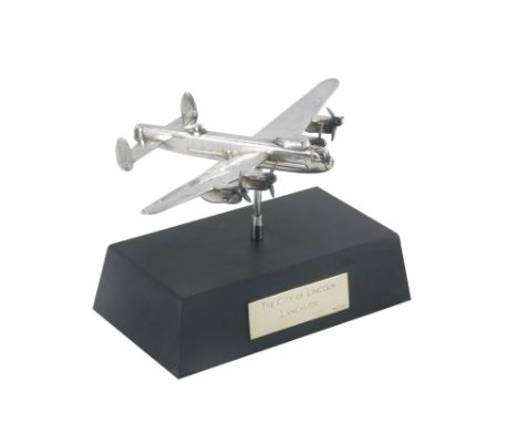 An Elizabeth II silver model of a Lancaster Bomber, on a plinth base, the plaque stating The City of Lincoln Lancaster, limit