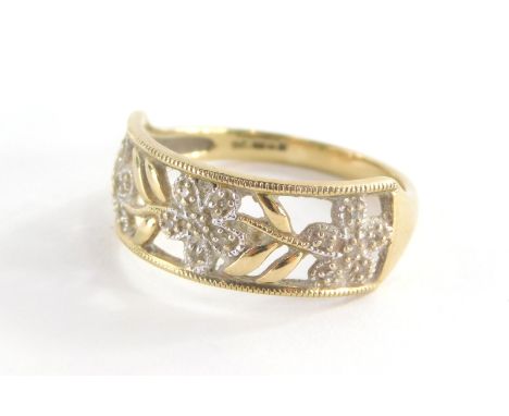 A 9ct gold dress ring, with rectangular panel set with three flowers and six leaf design, each set with cz stones, in oval pi