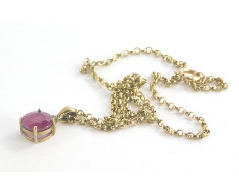 A 9ct gold ruby and diamond pendant and chain, the pendant with round brilliant cut ruby, 9.6mm diameter, 5.4mm deep, with ti