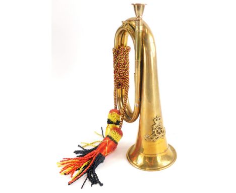 A Royal Artillery brass bugle, with rope tassels and Ubigue crest cast to front, 28cm long.Auctioneer Announce: This is an In