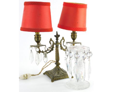 An early 20thC glass candlesticks, with various glass droplets, on a circular base, 16cm high and an early 20thC cast metal t