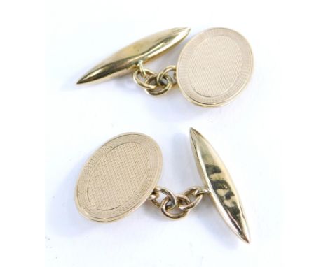 A pair of 9ct gold cufflinks, with oval engine turned shield, with curb link chain on bar backs, 4.8g.