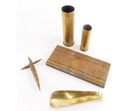 Trench Art. To include two shell cases, a brass shoe horn, possibly made from a shell case, a crucifix figure made from bulle