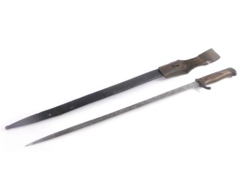 A German sword type bayonet with leather and metal scabbard, carved wooden handle, the blade stamped WRC Soligen, the guard s