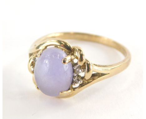 A 9ct gold dress ring, with central pale purple cabachon cut amethyst, and cz set shoulders and twist knot and pierced design