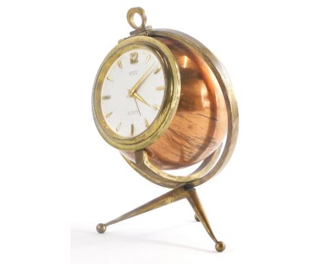 A mid 20thC copper and brass carriage clock, modelled in the form of a globe with revolving stand, the dial stamped Lancel Pa