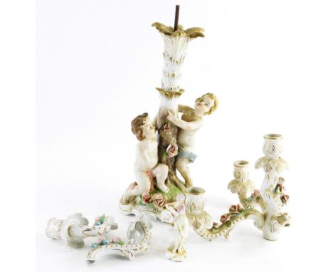 A continental porcelain three branch candelabra, supported by two putti with flower encrusted base, the base 39cm high, (AF),