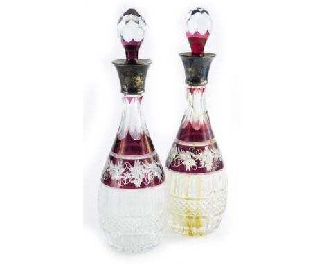 A pair of 19th/early 20thC Bohemian glass decanters, each with a silver collar, the body decorated with grapes, vines, leaves