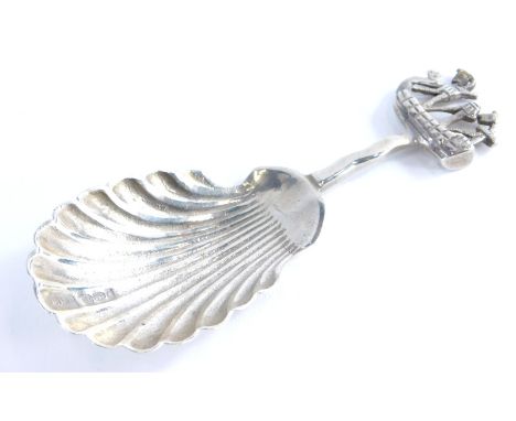 An early 20thC caddy spoon, with shell shaped bowl and boat handle, hallmarked with import marks, white metal, 8cm high, 0.4o