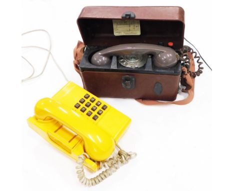 A yellow push button telephone, and a field or portable phone. (2)