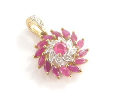 A 9ct gold ruby and diamond floral pendant, with central wave design flower on two rows bordering with central rubies, surrou